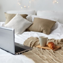 a laptop and breakfast in bed