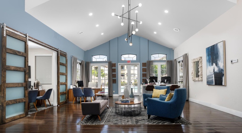 a room with a wood floor and a chandelier