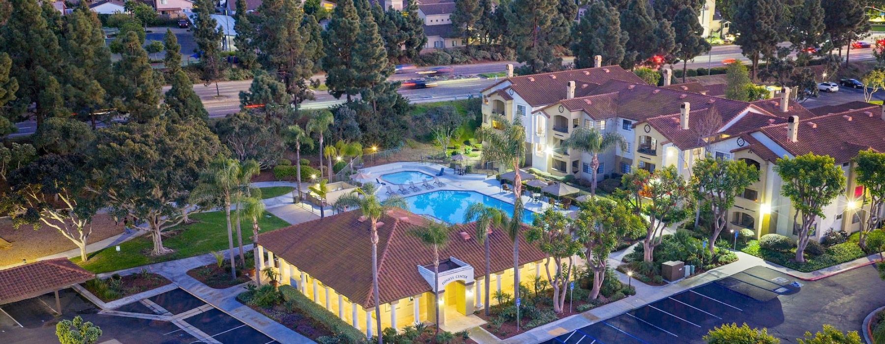 an aerial of a building, pool, and a city