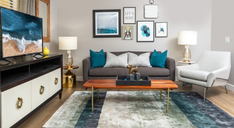a living room with a couch, tv and tables