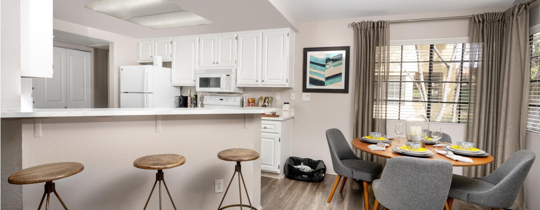 a kitchen with a table and chairs
